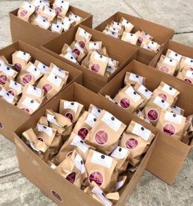 Bagged meals with Parkway Diner on them in cardboard boxes