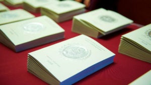 Program booklets sit stacked atop a table.