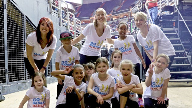 Susannah Pierce Keefe poses with two adults and a group of preschoolers.