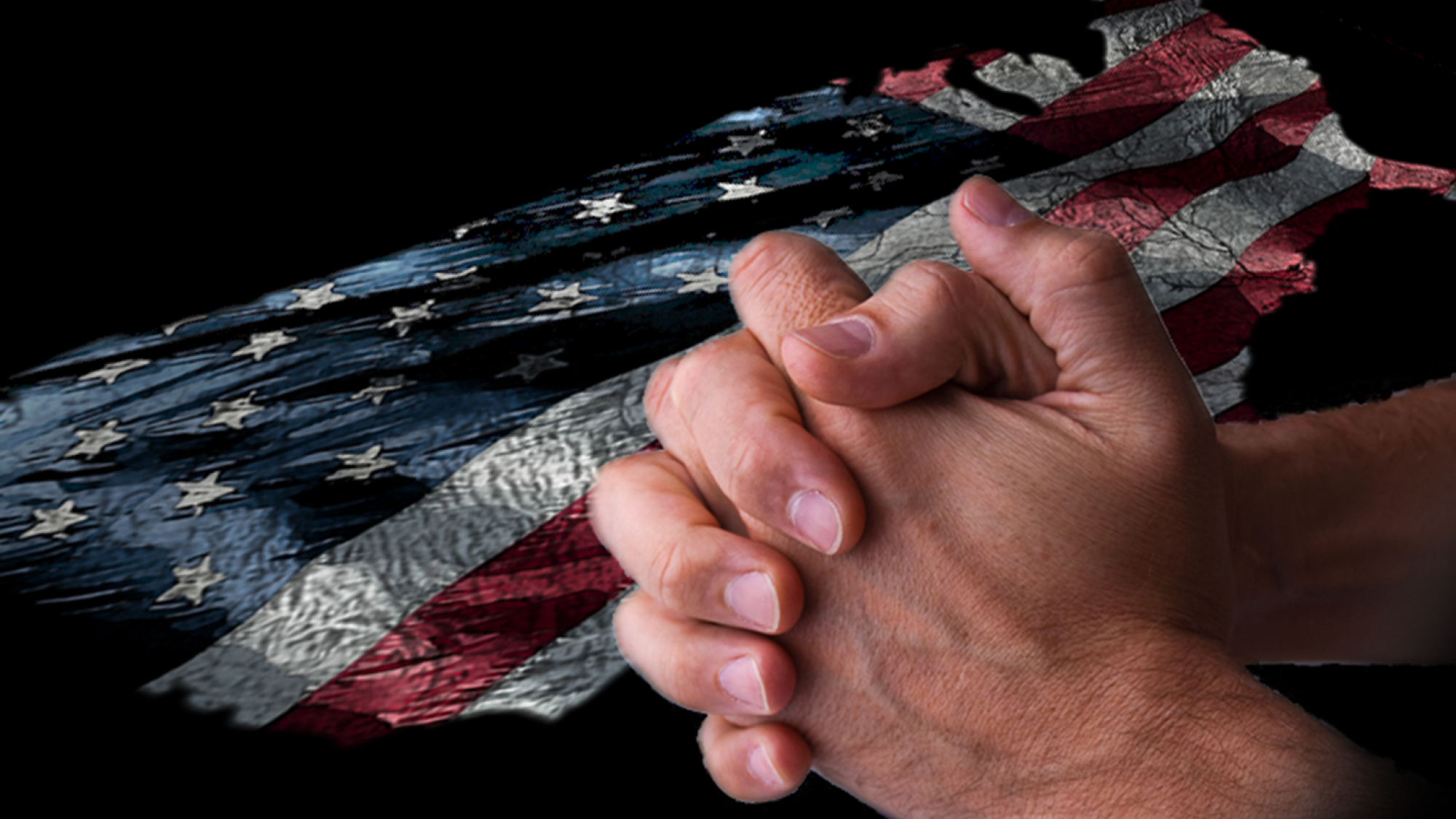 Man holding hands in prayer over USA flag background