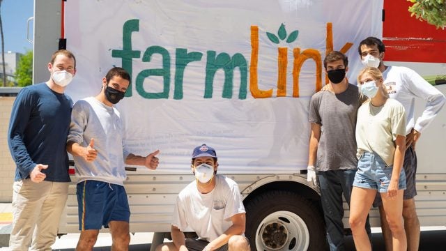 Six students stand in front of a banner that reads FarmLink.