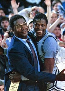 John Thompson Jr. and Patrick Ewing embrace in celebration on the court after a game.