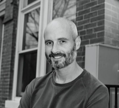 Brian McCabe in front of a brick building