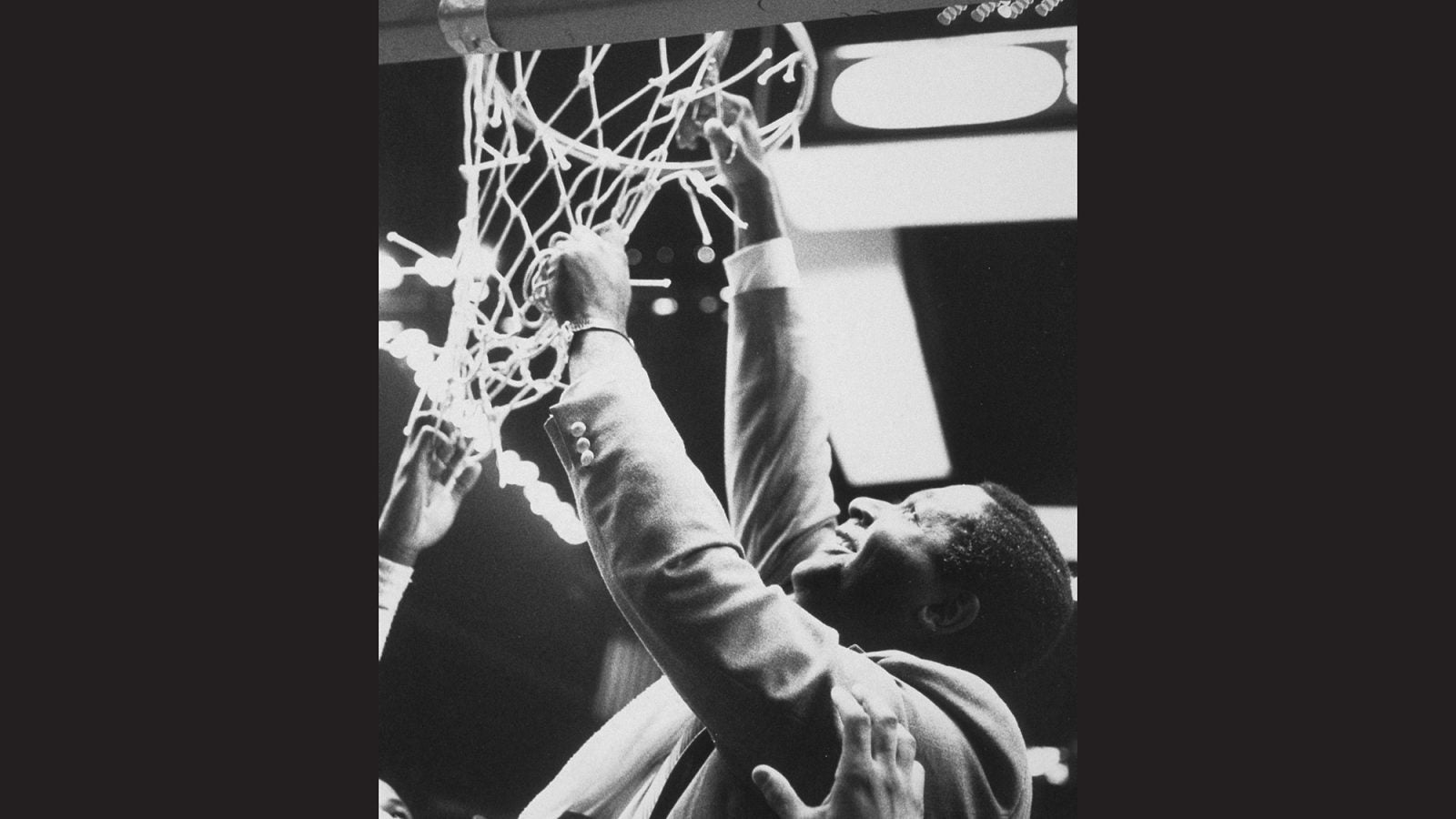 John Thompson Jr. cuts the basket ball net after victory