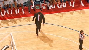 An aerial view of John Thompson Jr. walking across the basketball court.