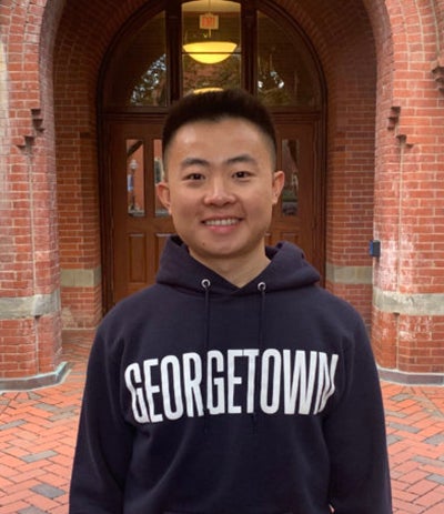 Bryan Zou wearing a Georgetown sweatshirt