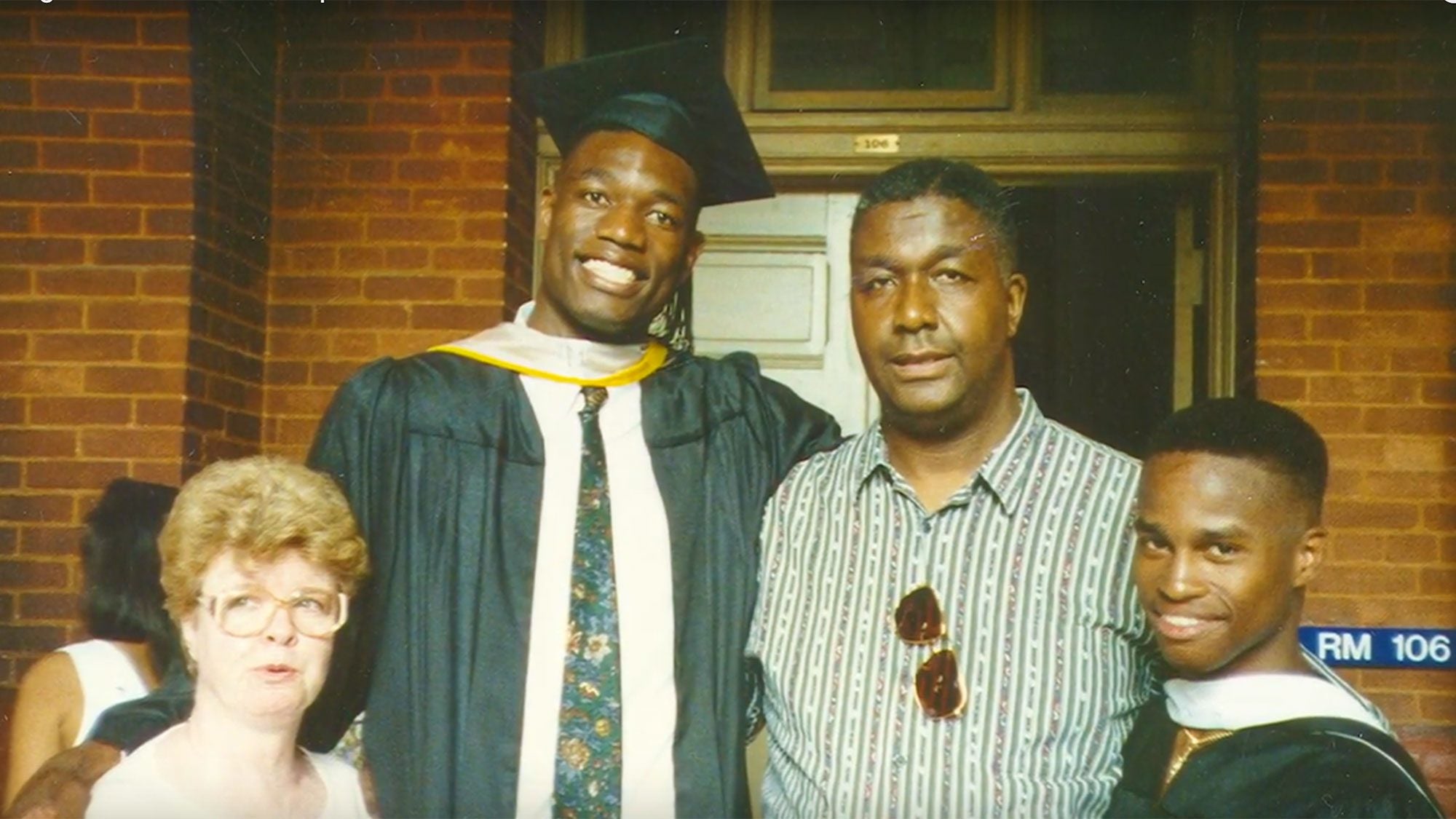 Mary Feli, Dikembe Mutombo, John Thompson Jr. and another recent graduate stand together in Healy Hall.