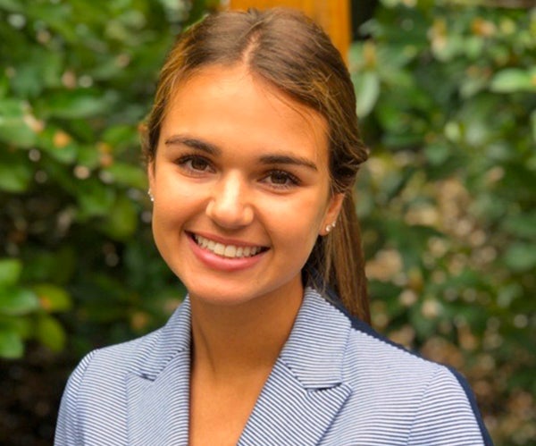 Maya Fernandez-Powell outside in front of greenery