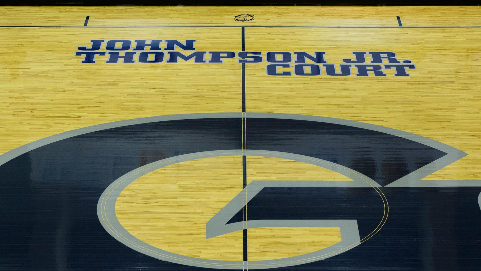 A basketball court with the Geogetown logo and John Thompson Jr. name on the court.