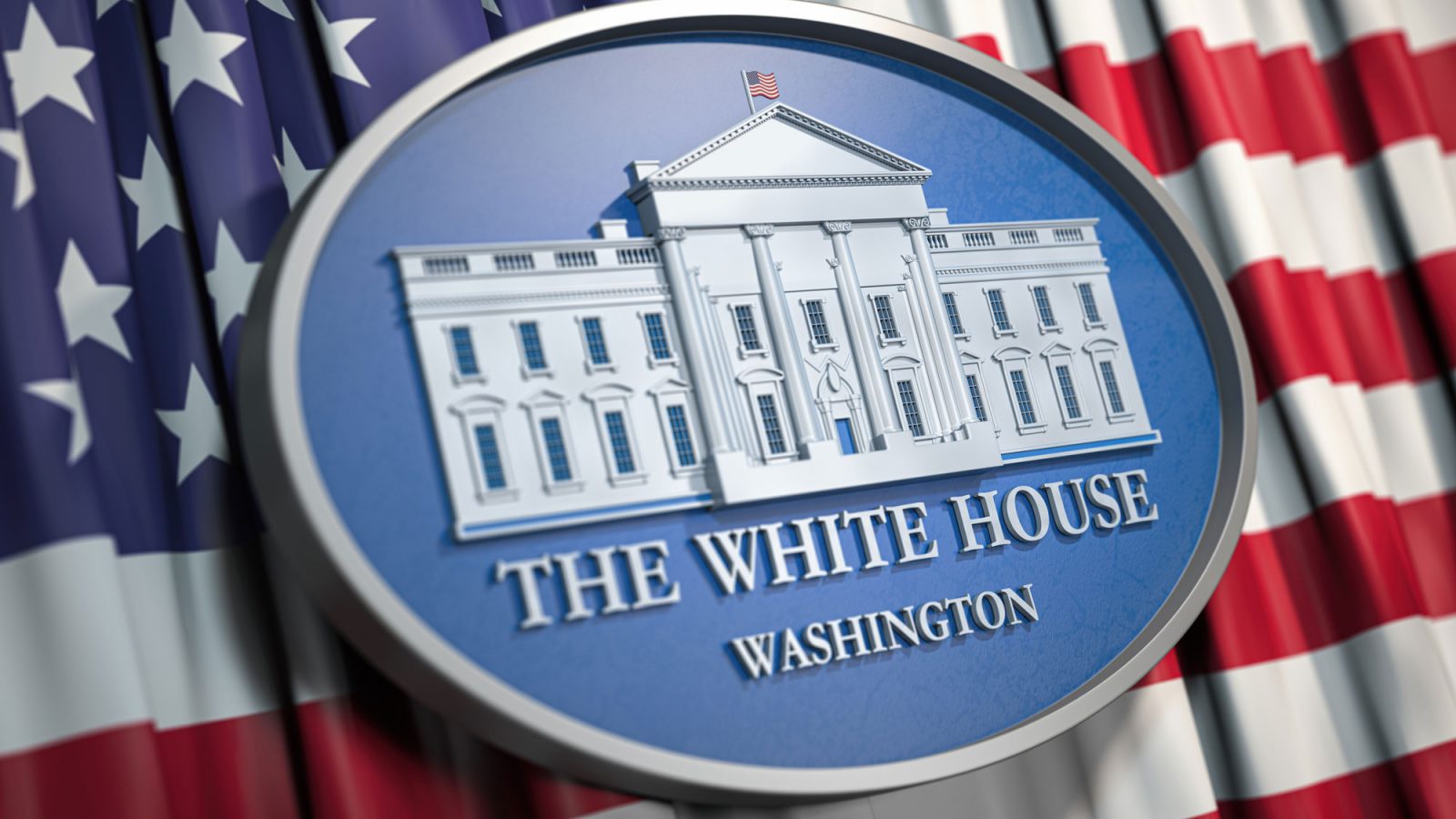 Oval White House plaque lies against an American flag backdrop.