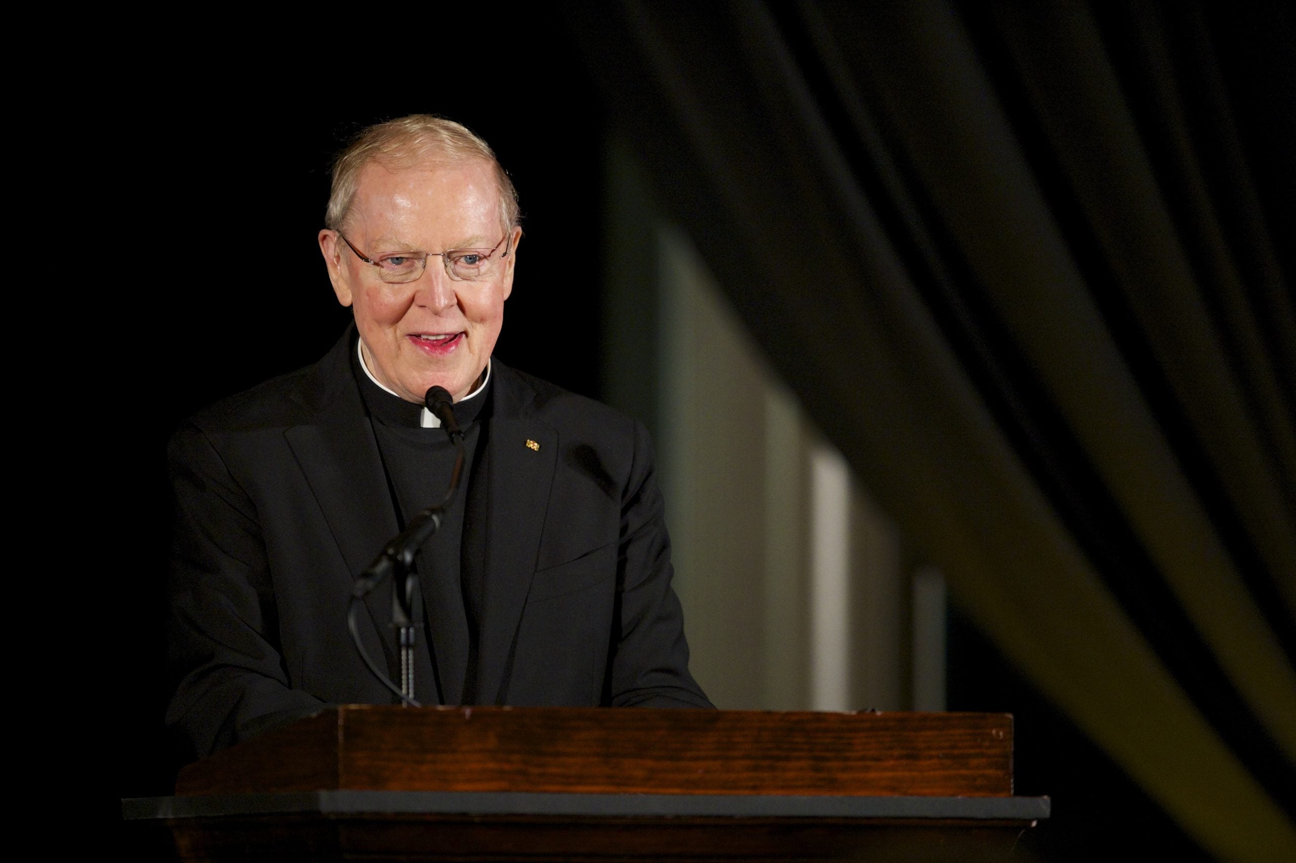 Father Leo J. O'Donovan speaks at a podiium