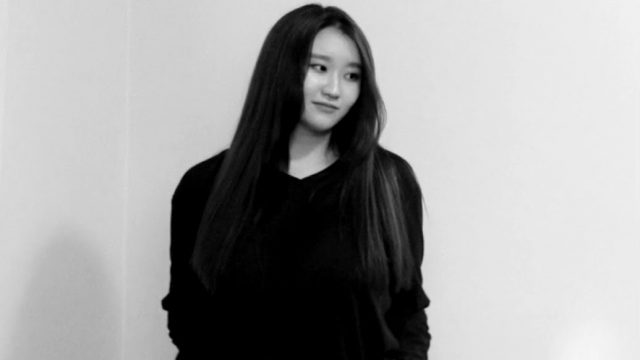 Black and white photo of Irene Chun with her hands in her pocket