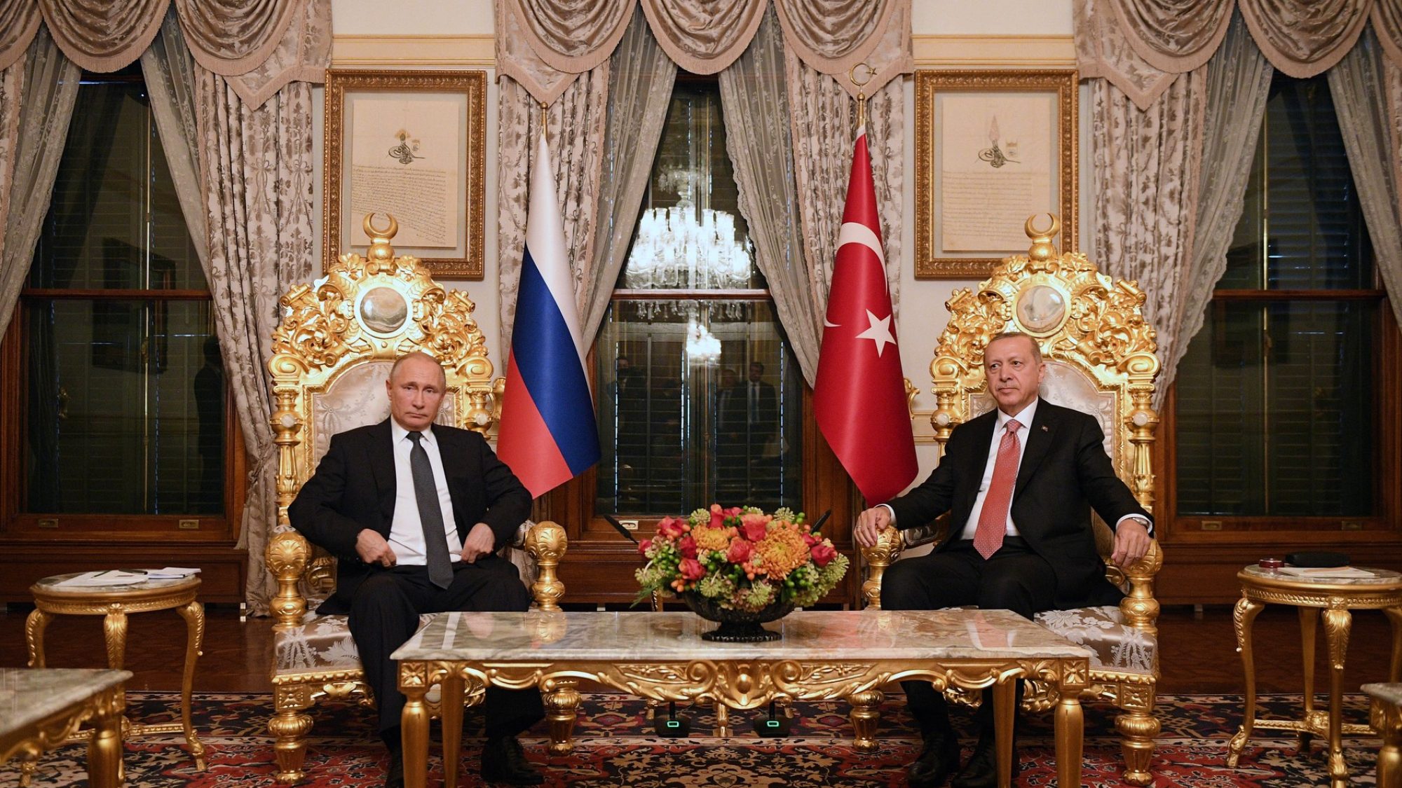 Russian President Vladimir Putin and Turkish President Recep Tayyip Erdoğan sit in a luxuriously decorated room in Istanbul