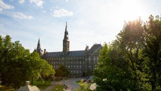 Sun shines on Healy Hall from a distance