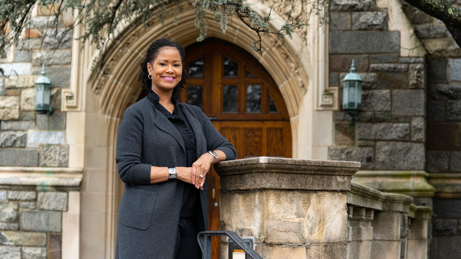 Soyica Diggs Colbert stands in front of a stone building