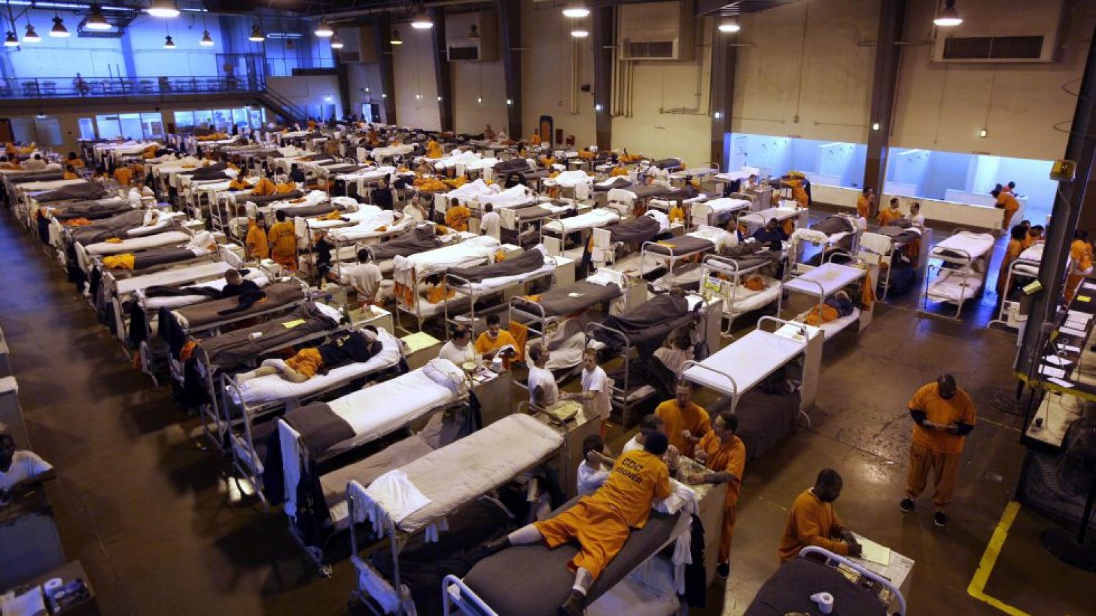 Several hundred inmates crowd the gymnasium at San Quentin prison in San Quentin, Calif.