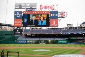 Anthony Fauci and Christine Grady on the Jumbotron at Nats Park