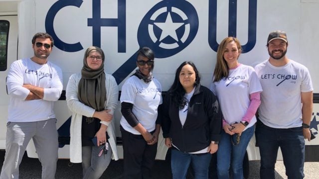 Jordan Foley and five Chow fellows stand in front of a food truck