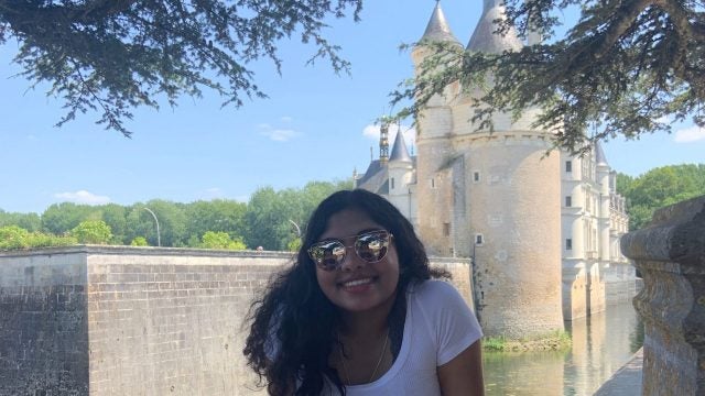 Varsha Menon in front of a castle in France