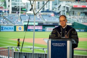 President DeGioia speaks from a podium at Nationals Park