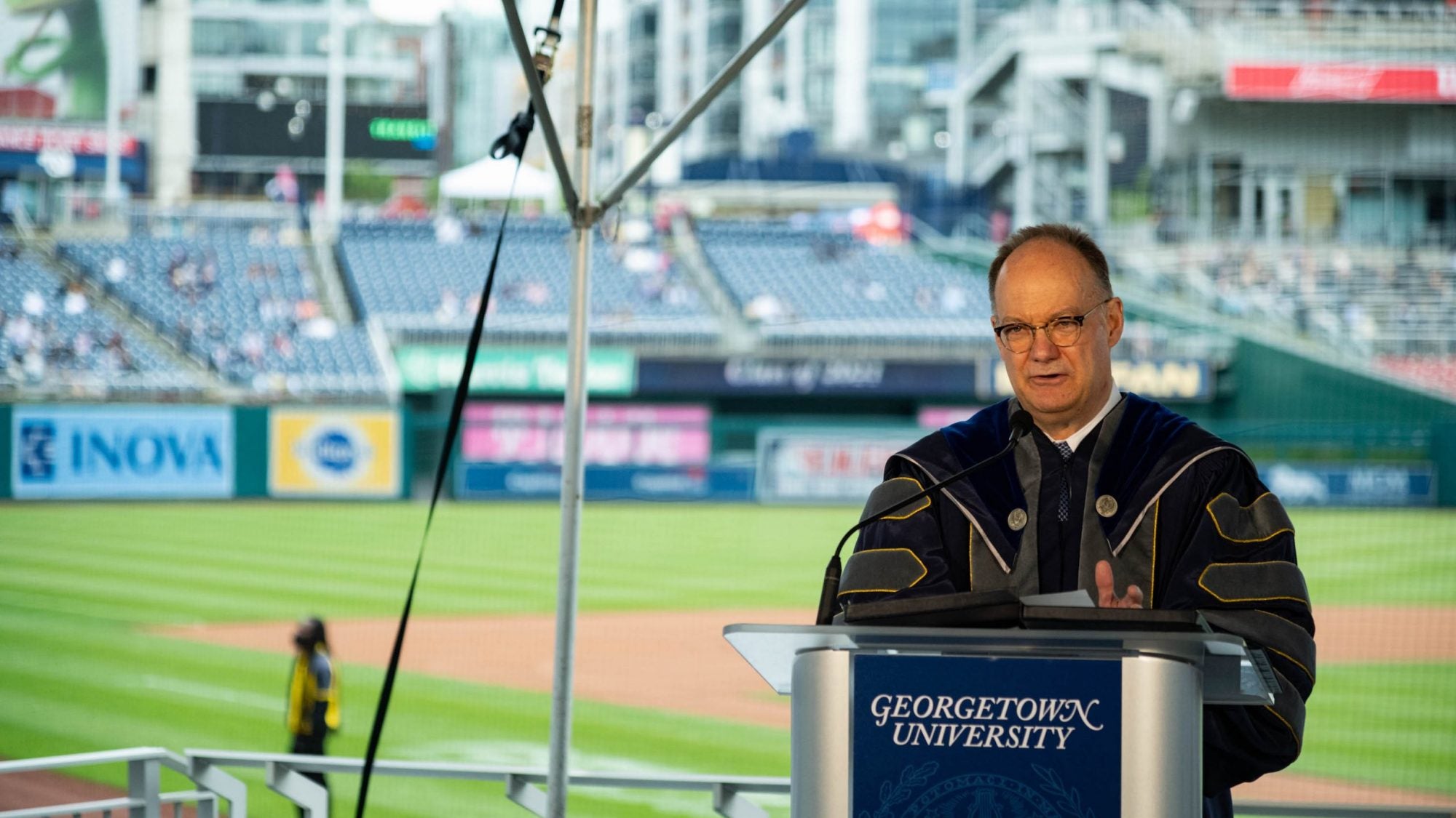 President DeGioia speaks from a podium at Nationals Park