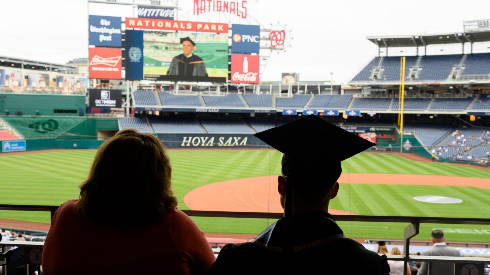 A graduating student and their guest look at Nats Park
