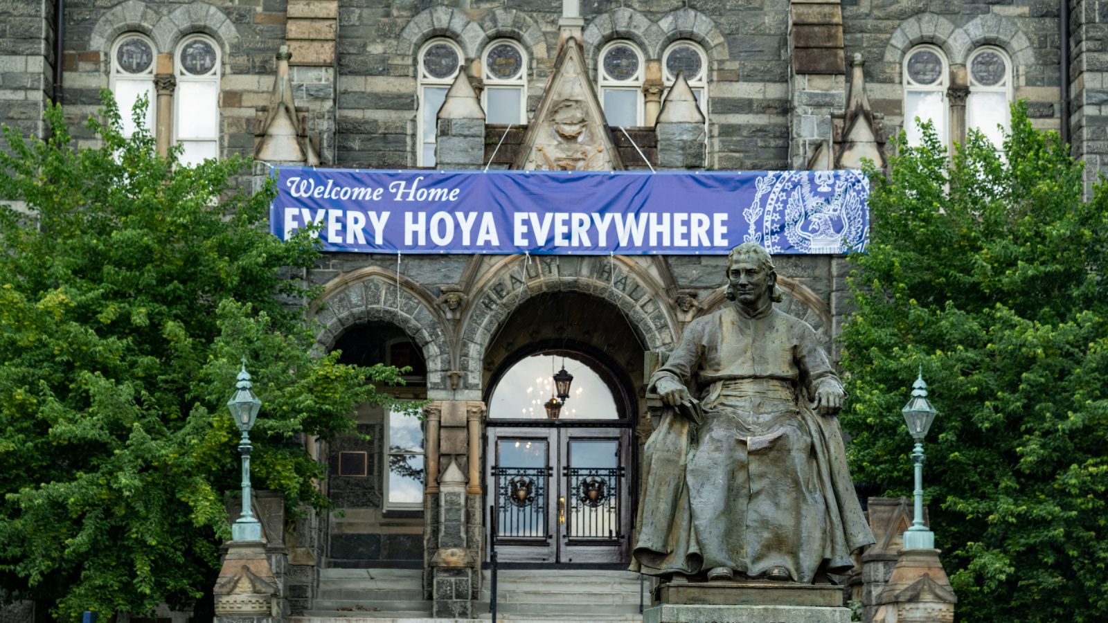 John Carroll statue in front of Healy Hall with the sign 