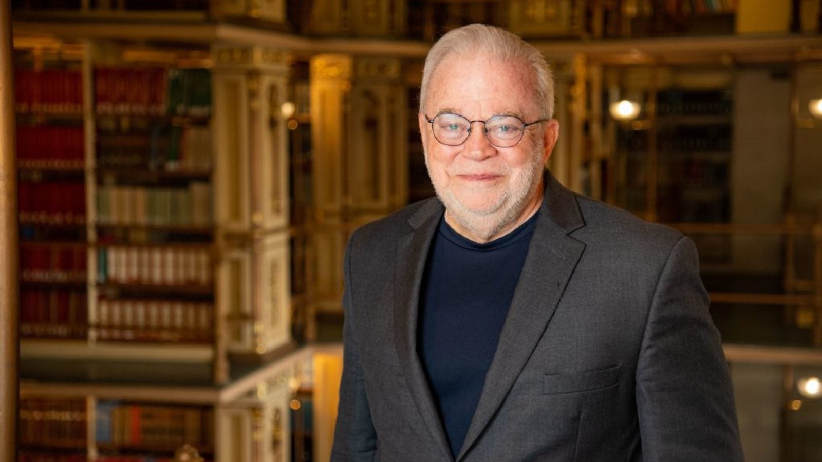 Jim Wallis stands in front of bookshelves