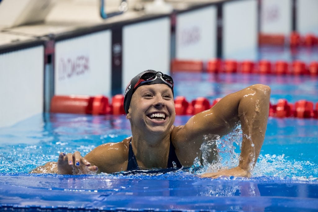 Michelle Konkoly leans over a swimming lane in a pool