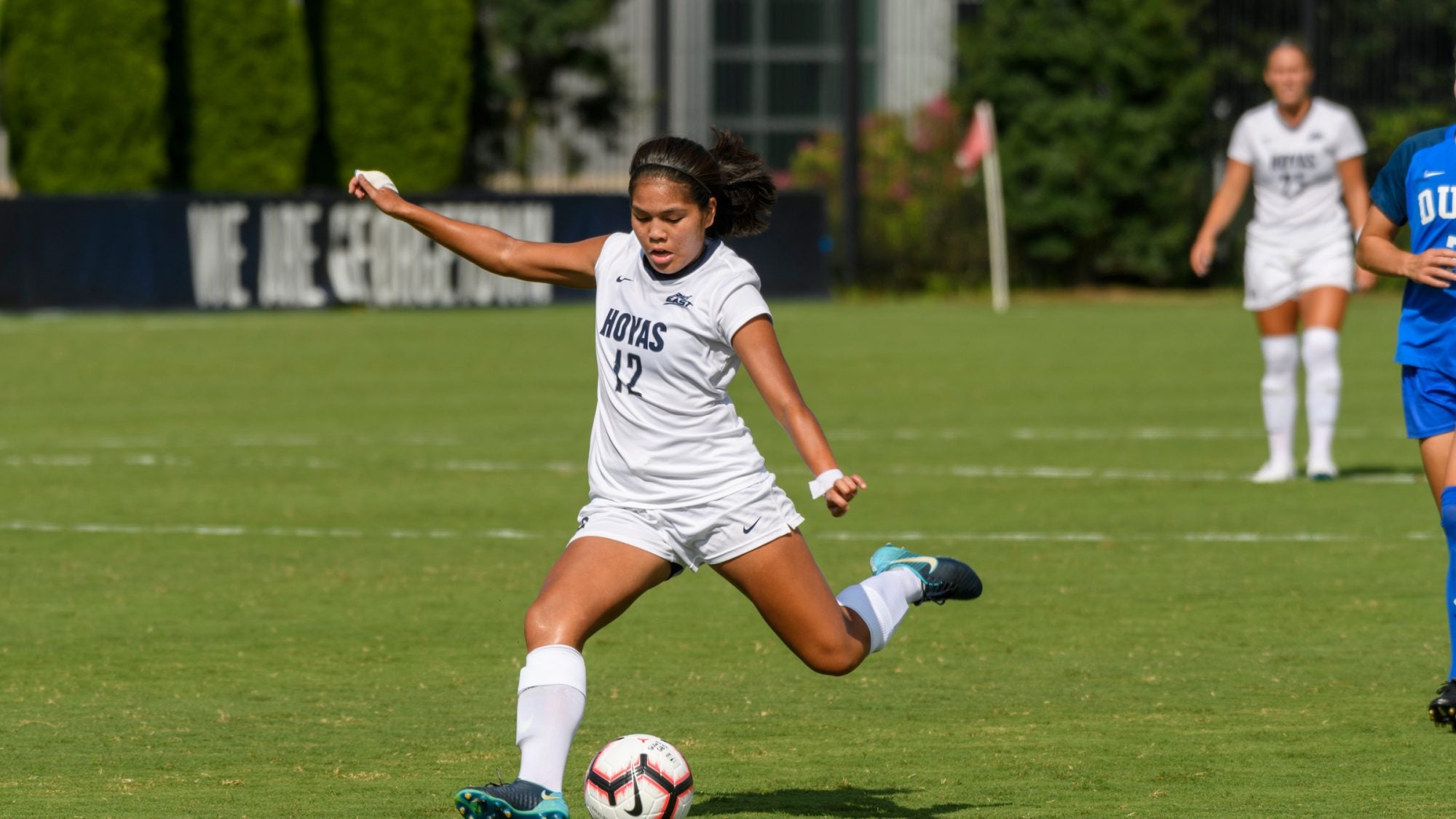 Student athlete kicks a soccer ball