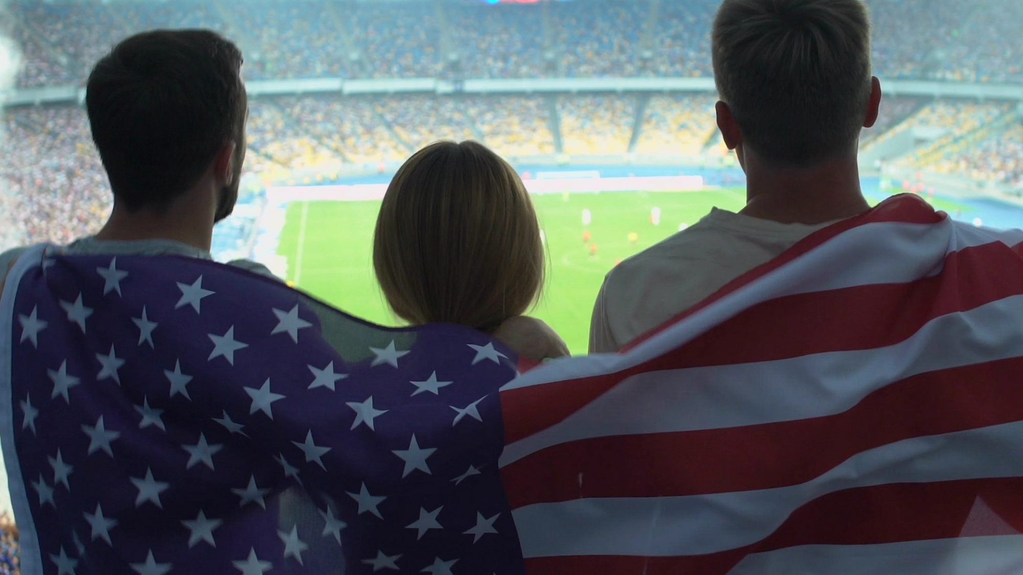 Fans in stadium with United States flag.