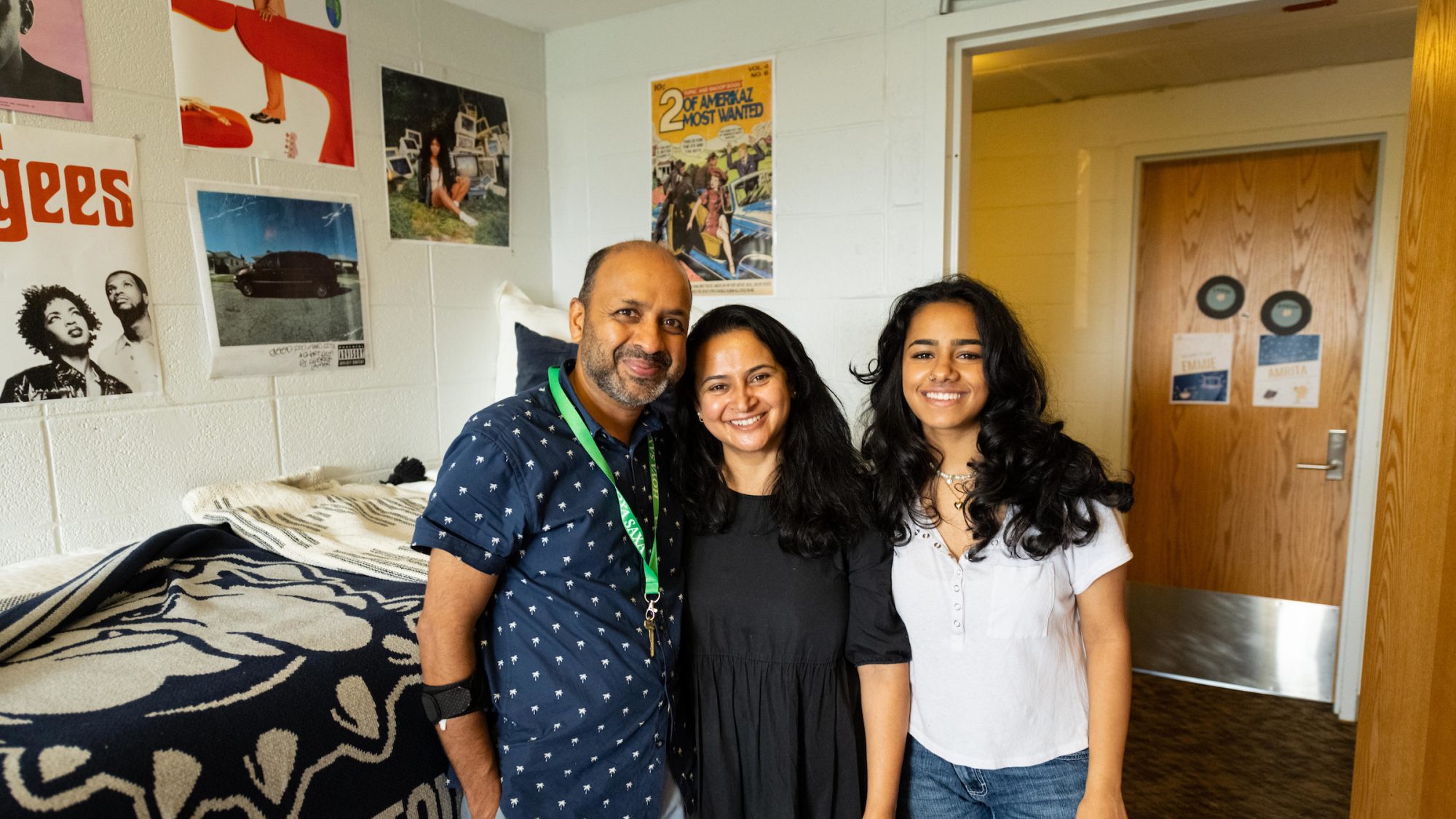 Father, mother and daughter in a dorm room