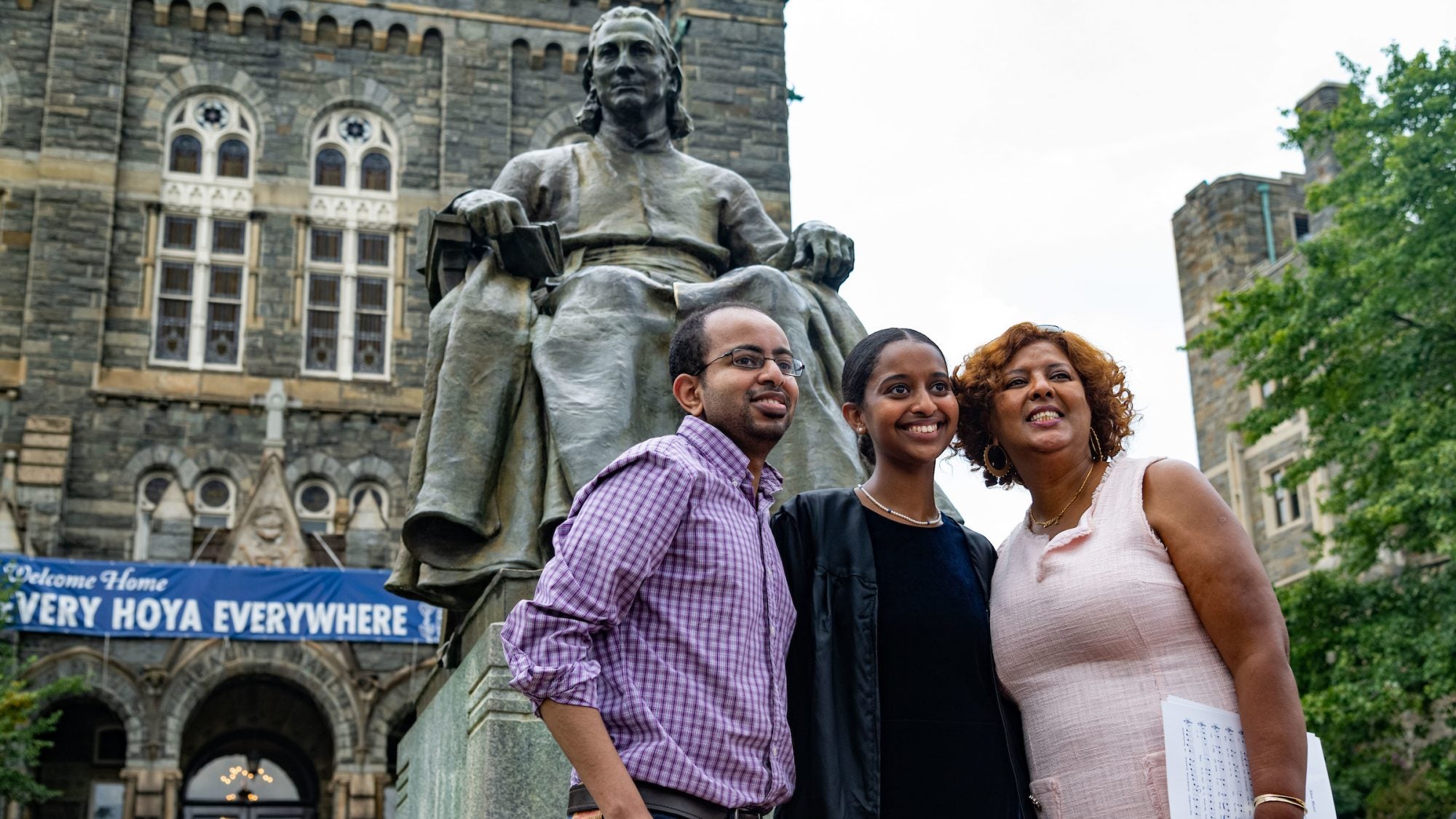 Family poses in front of John Carroll statue