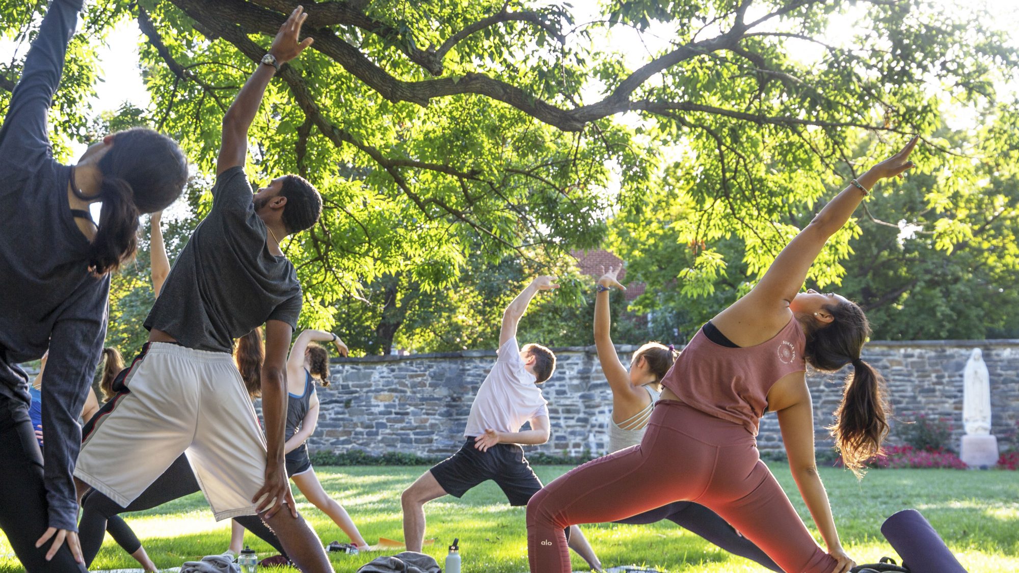 Image of Georgetown students taking a yoga class on Healy Lawn.