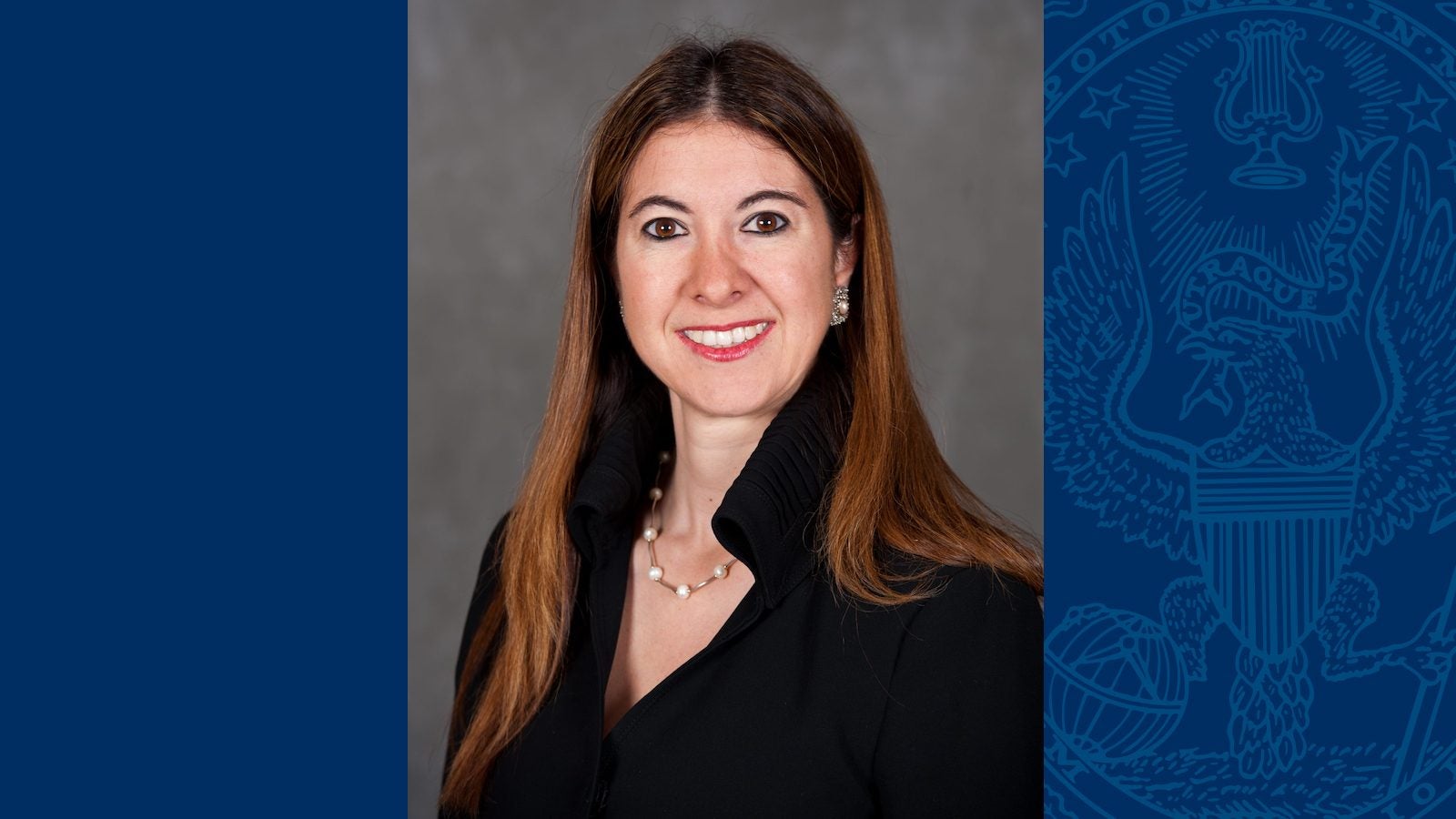 Headshot of Adriana Kugler with a blue background with the Georgetown seal overlaid