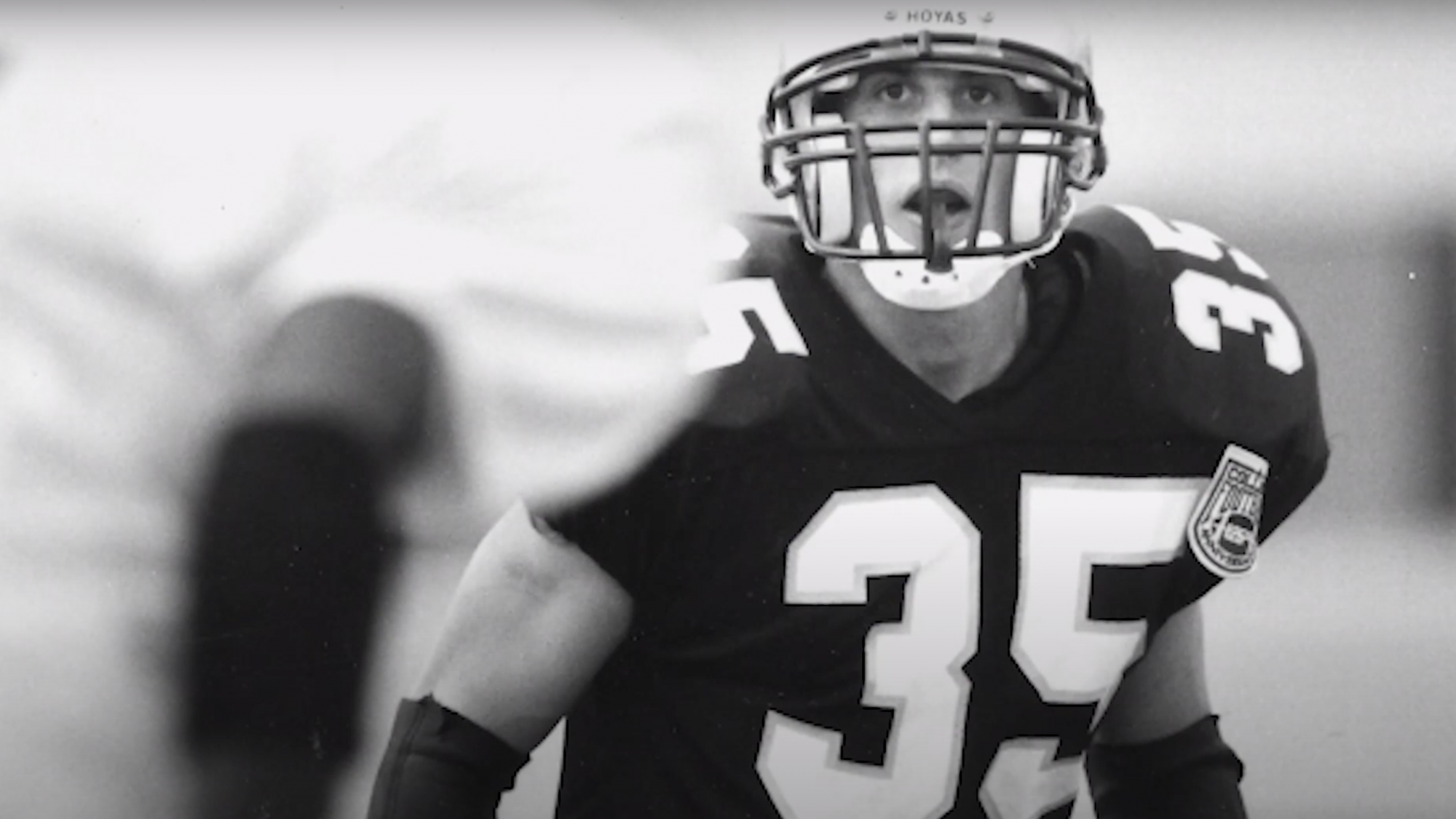 Black and white image of a football player wearing the number 35