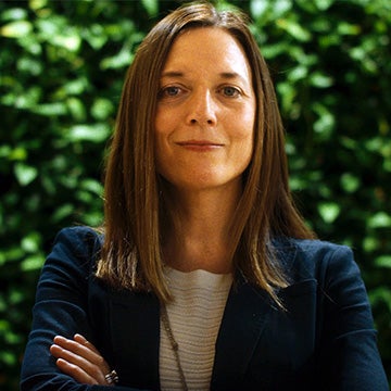 Meghan Chapple headshot in front of green wall