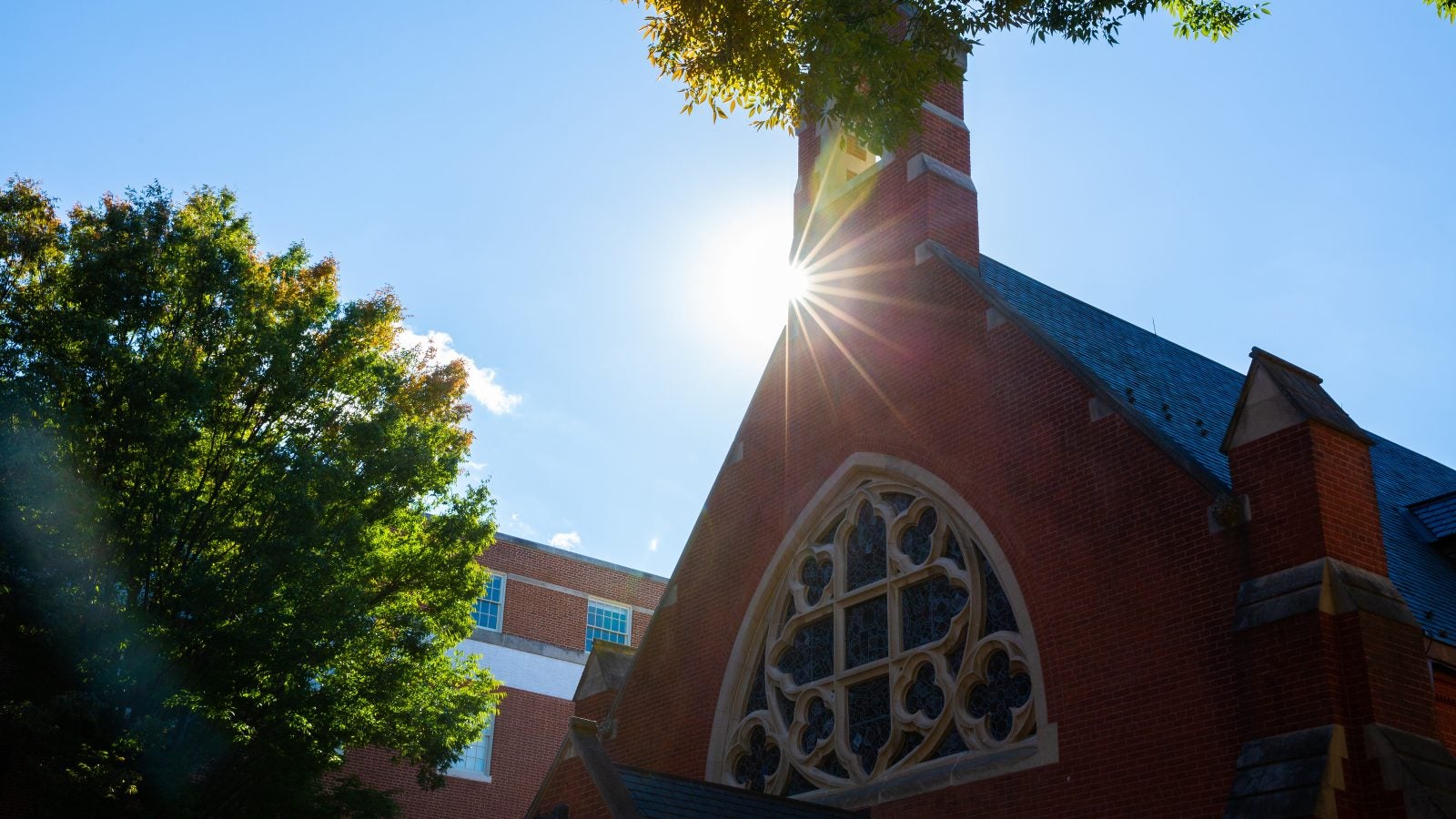 Sun flare behind the tower of Dahlgren Chapel