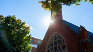 Sun flare behind the tower of Dahlgren Chapel