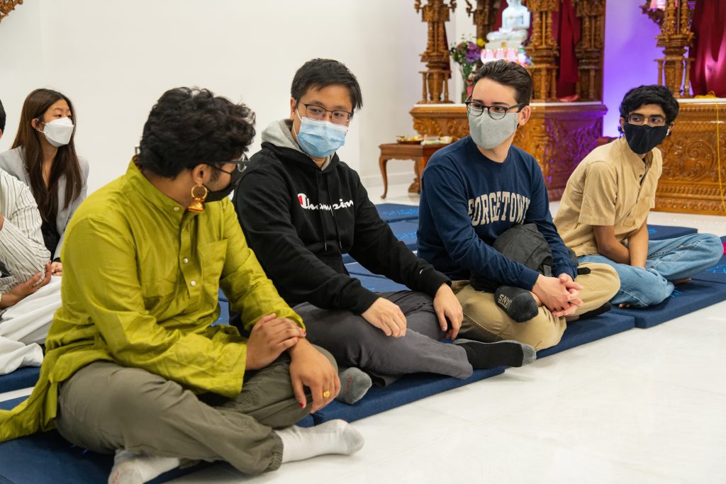 Four students pictured at the opening of Georgetown's new Dharmic Meditation Center.