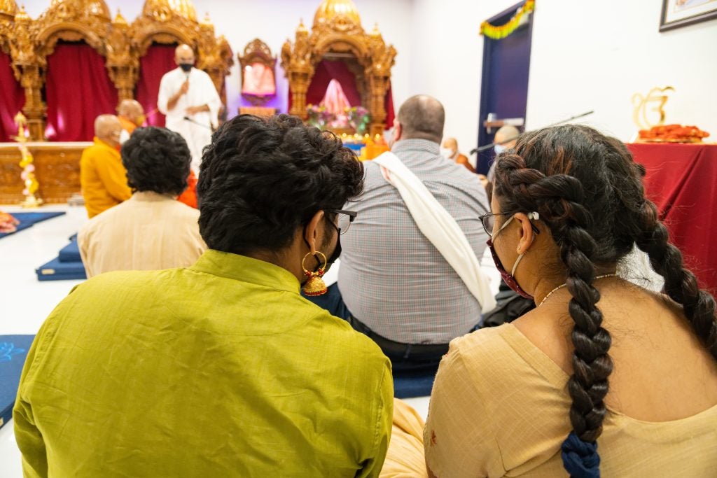 Two students pictured at the opening of the Dharmālaya, a new meditation center for members of Dharmic spiritual traditions.