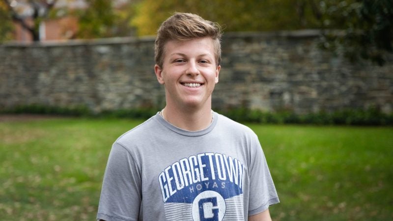 Jackson wears a gray Georgetown T-shirt in a headshot outside