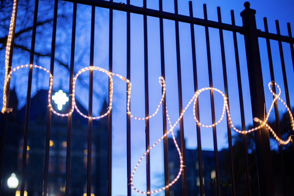 "Hoyas" spelled out in Christmas lights on the Healy gates