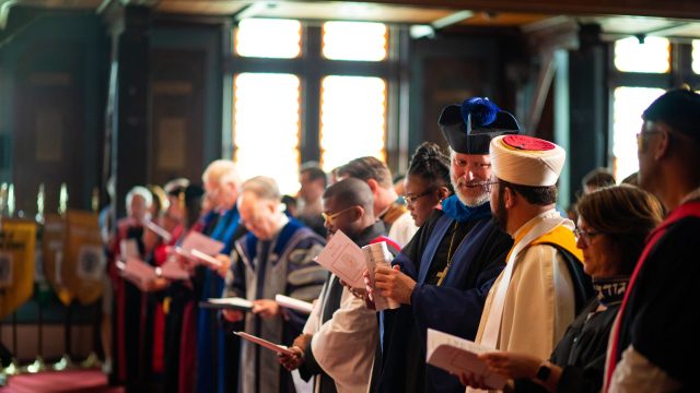 Chaplains in religious garments from different traditions interacting