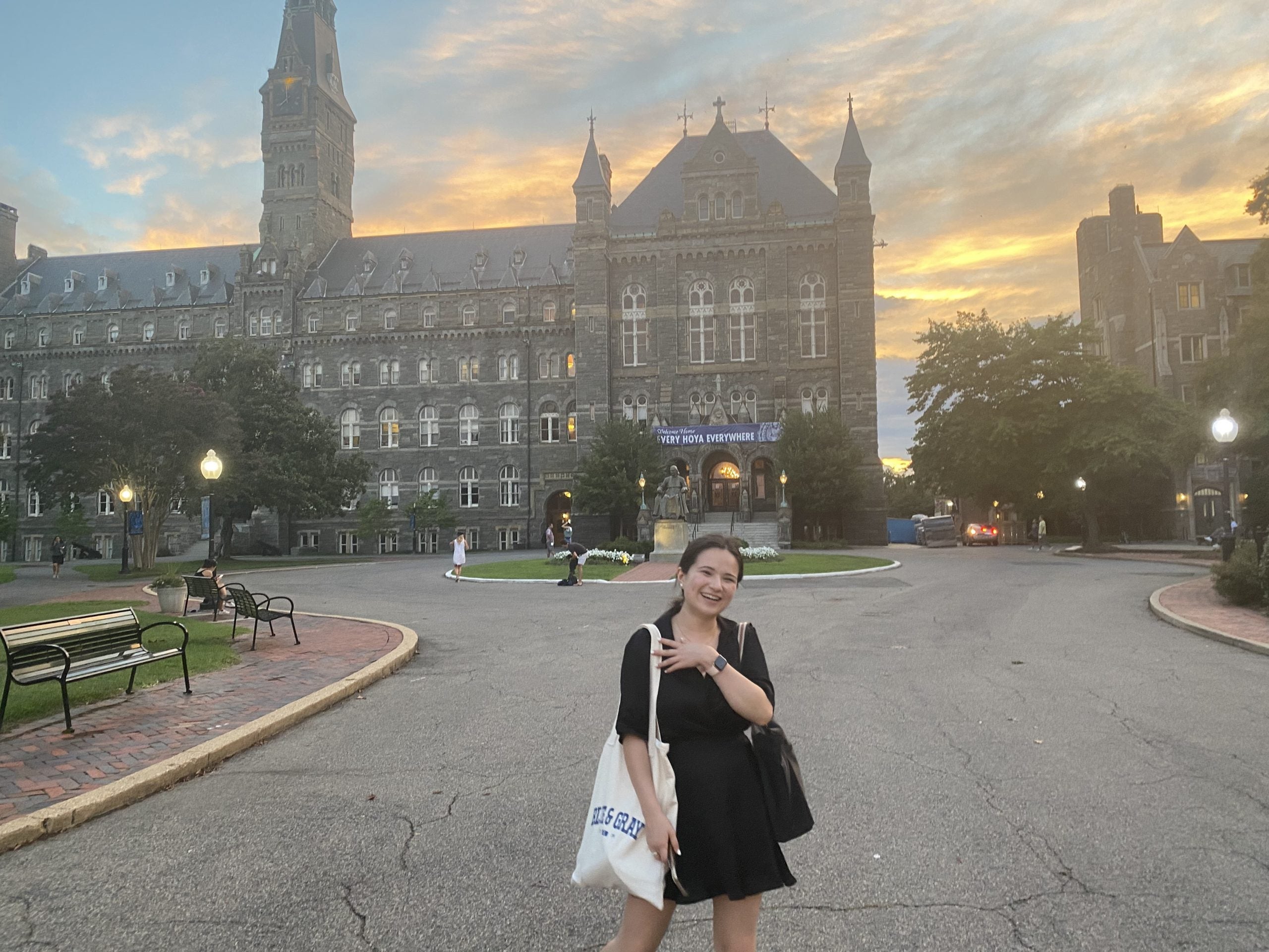 Bayley holds a tote bag in front of Healy Circle