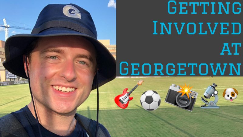 Kirk wears a blue Georgetown bucket hat with the text &quot;Getting involved at Georgetown&quot; with guitar, soccer ball, camera, microscope and dog emojis