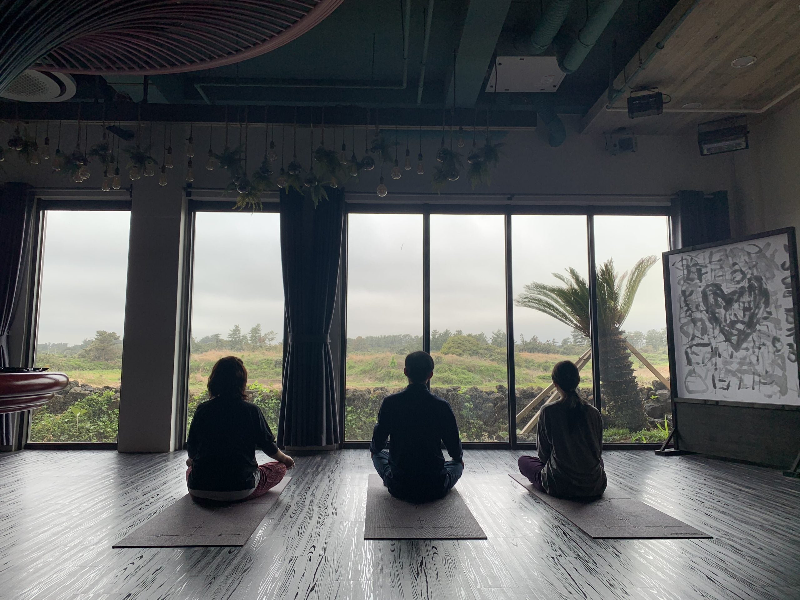 Shana Shin and her parents meditate on prayer mats at a meditation center in South Korea.