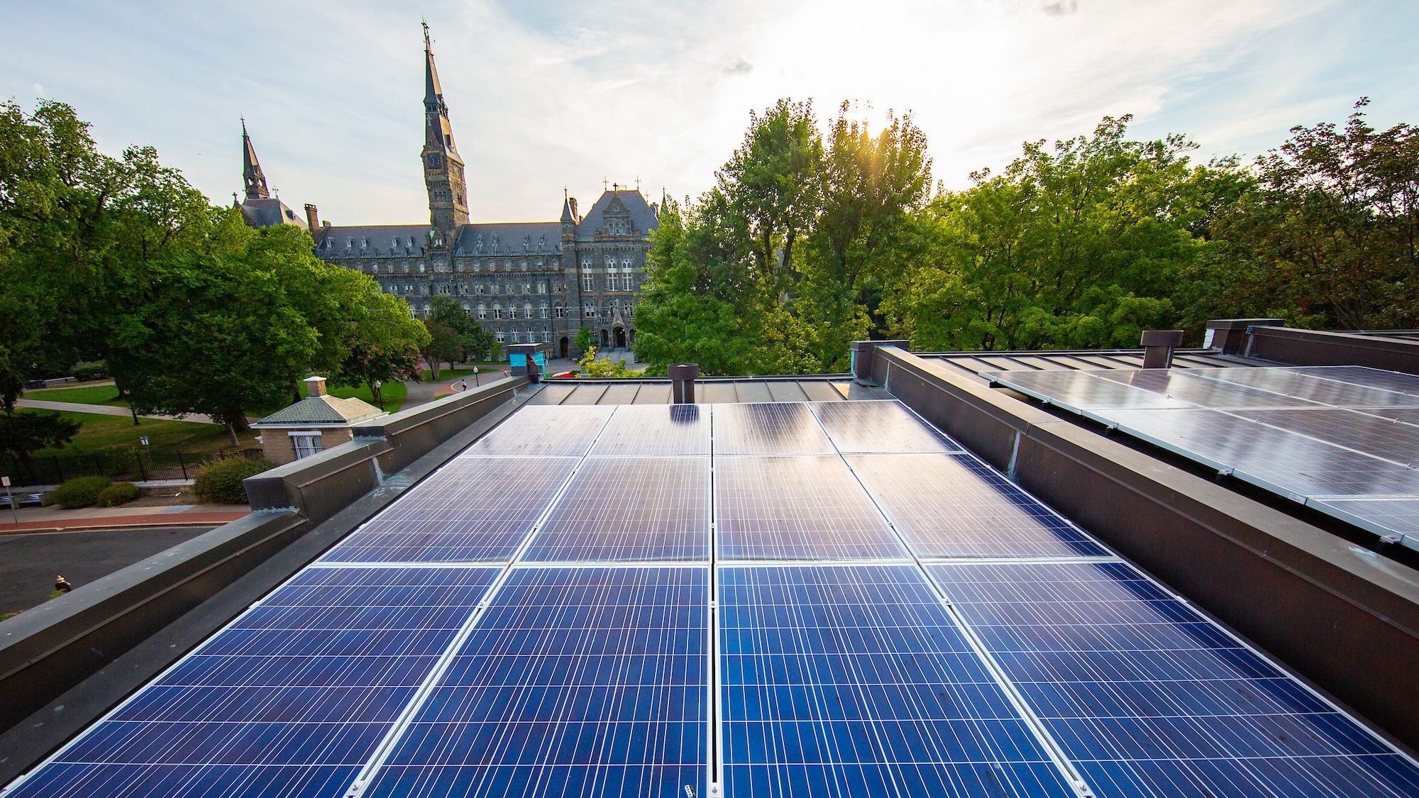 Rooftop solar panels with Healy Hall in background