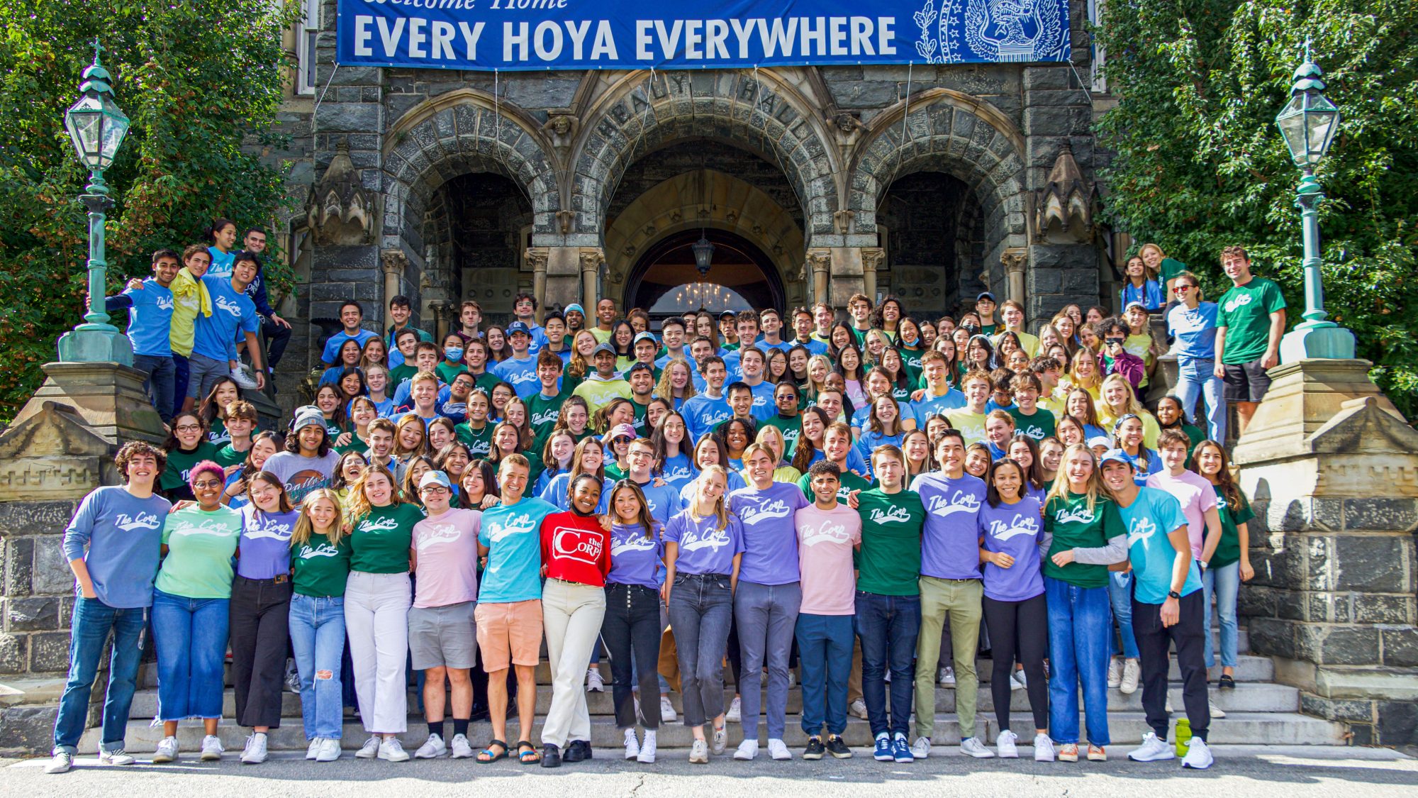 Group photo of Corp employees wearing Corp T-shirts on Healy steps