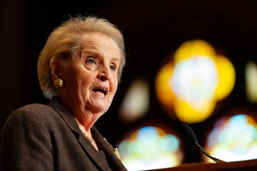 Madeleine Albright speaks in front of stained glass